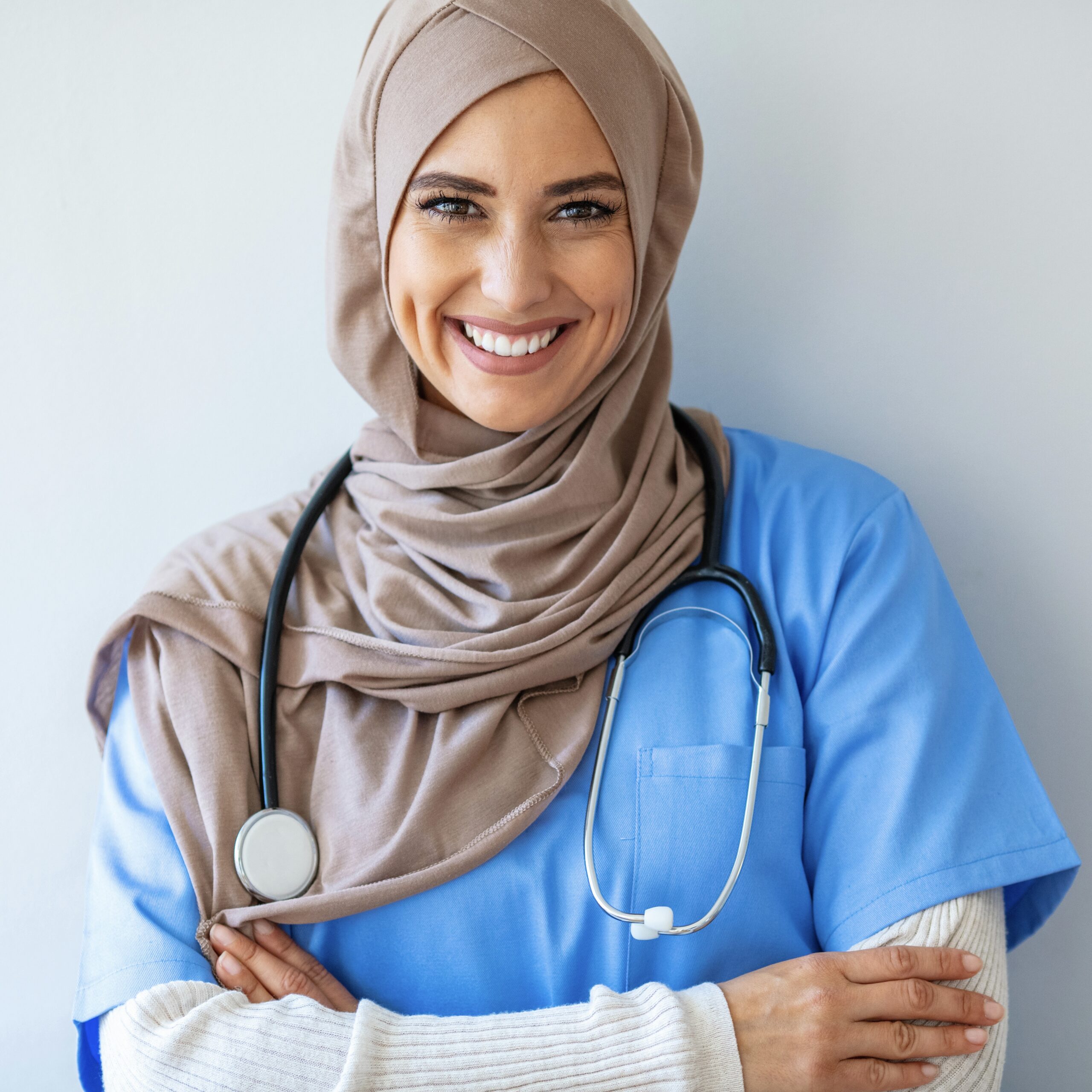 Confident Muslim female doctor standing inside hospital. Portrait of Muslim Doctor with stethoscope. Confident Muslim medical student pose at hospital. Confident Muslim doctor